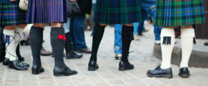 Four pairs of kilt socks under tartan kilts